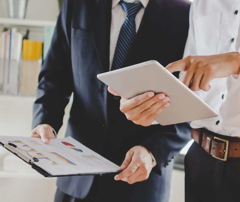 Two people discussing charts