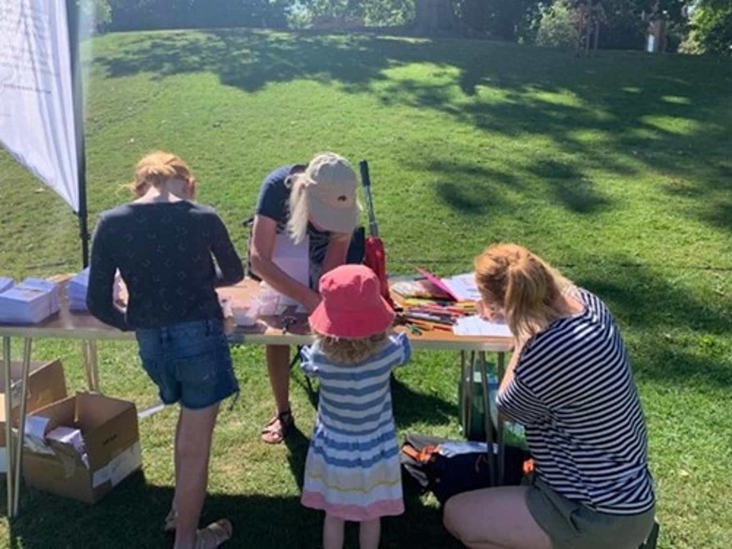 Adults and children crafting at a table